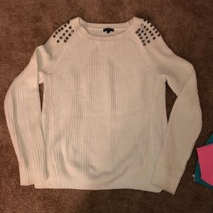 cream sweater with should studs